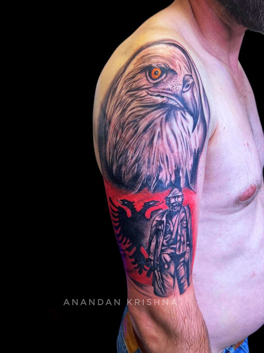 Colour realism eagle and figure half-sleeve tattoo at Divine Arts Tattoos.