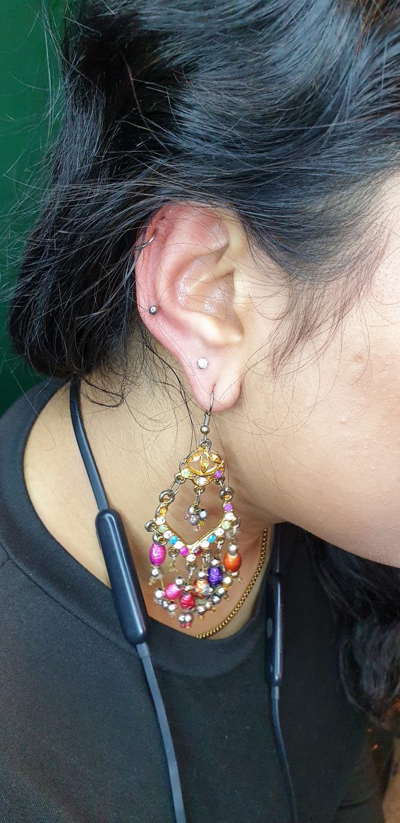 Fresh ear piercings with a jewelled stud at Divine Arts Tattoos, Walthamstow.